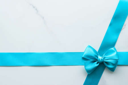 Holiday decor, feminine design and flatlay concept - Blue silk ribbon on marble, top view