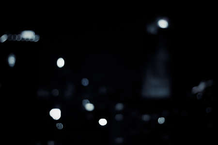 Big metropolitan city lights at night, blurry background - night life, abstract background and modern dark tones conceptの写真素材