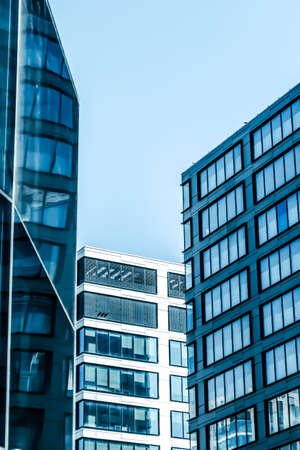 Business, city lifestyle and futuristic design concept - Contemporary office building in financial district, modern urban architectureの写真素材