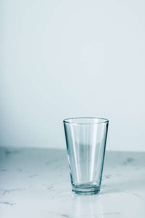 Glassware, washing and purity concept - Clean empty glass on marble tableの写真素材