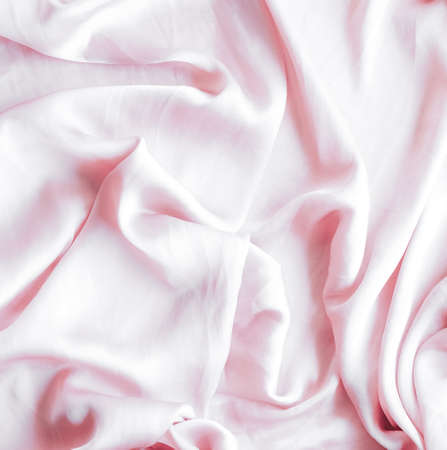 Elegant fabric texture, abstract backdrop and modern pastel colours concept - Pink soft silk waves, flatlay backgroundの写真素材