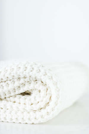 Knitwear, fabric textures and handmade items concept - Warm knitted clothes, soft and white