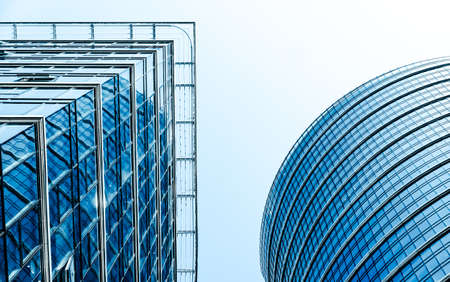 Business, city lifestyle and futuristic design concept - Contemporary office building in financial district, modern urban architectureのeditorial素材