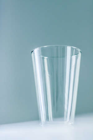 Glassware, washing and purity concept - Clean empty glass on marble tableの写真素材