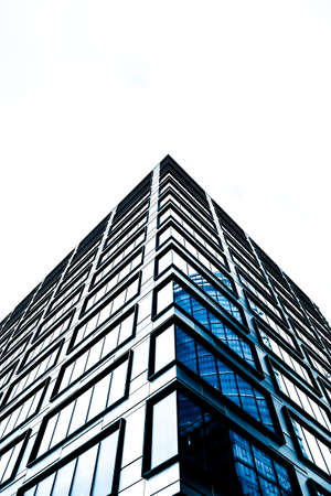 Business, city lifestyle and futuristic design concept - Contemporary office building in financial district, modern urban architectureのeditorial素材