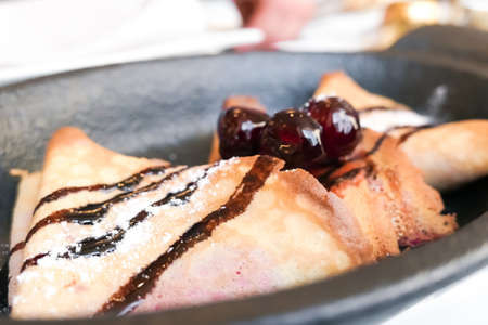 Sweet dessert, breakfast food and luxury service - French crepes with chocolate sauce and cherries in a reastaurant in Paris, pancakes recipeの写真素材