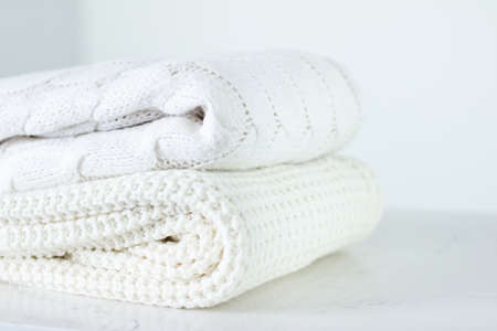 Knitwear, fabric textures and handmade items concept - Warm knitted clothes, soft and white