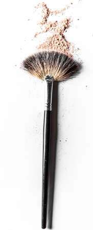 Beauty texture, cosmetic product and art of make-up concept - Brush and beige powder close-up...