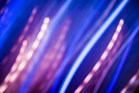 Technology, defocused textures and futuristic design concept - Neon lights background, abstract lines in motionの写真素材