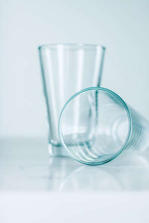 Glassware, washing and purity concept - Clean empty glasses on marble tableの写真素材