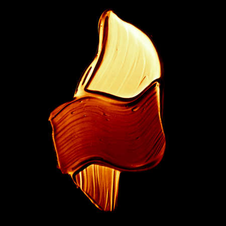 Art abstract, cosmetic product and hand painted design concept - Golden paint brush stroke texture isolated on black backgroundの写真素材