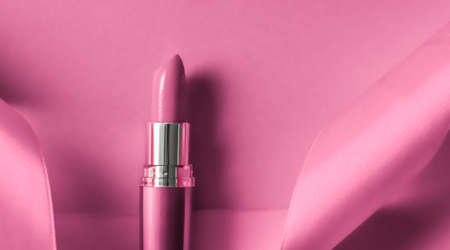 Cosmetic branding, glamour lip gloss and shopping sale concept - Luxury lipstick and silk ribbon on pink holiday background, make-up and cosmetics flatlay for beauty brand product designの写真素材