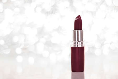 Cosmetic branding, sale and glamour concept - Chocolate lipstick on silver Christmas, New Years and Valentines Day holiday glitter background, make-up and cosmetics product for luxury beauty brandの写真素材