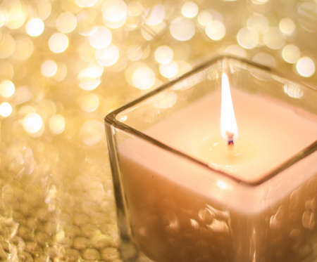 Festive decoration, branding and aromatherapy spa concept - Aromatic candle on golden Christmas and New Years glitter background, Valentines Day luxury home decor and holiday season brand designの写真素材