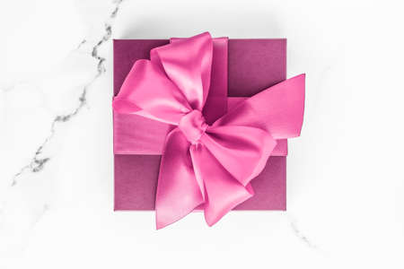 Birthday, wedding and girly branding concept - Pink gift box with silk bow on marble background, girl baby shower present and glamour fashion gift for luxury beauty brand, holiday flatlay art designの写真素材