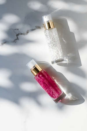 Cosmetic branding, packaging and make-up concept - Skin care serum and gel bottle, moisturizing lotion and lifting cream emulsion on marble, anti-age cosmetics for luxury beauty skincare brand designの写真素材