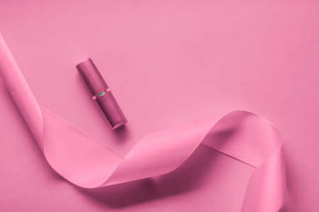 Cosmetic branding, glamour lip gloss and shopping sale concept - Luxury lipstick and silk ribbon on pink holiday background, make-up and cosmetics flatlay for beauty brand product designの写真素材