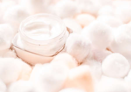 Cosmetic branding, moisturizing emulsion and facial care concept - Luxury face cream for sensitive skin and orange cotton balls on background, spa cosmetics and natural skincare beauty brand productの写真素材