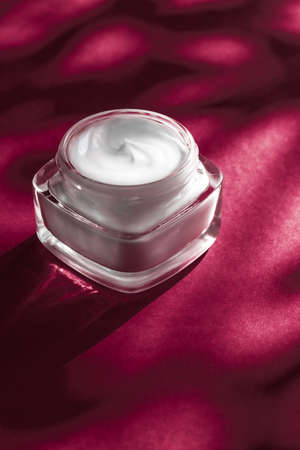 Anti-age moisturizer, luxe cosmetics and organic science concept - Moisturizing beauty face cream for sensitive skin, luxury spa cosmetic and natural clean skincare product on ruby backgroundの写真素材