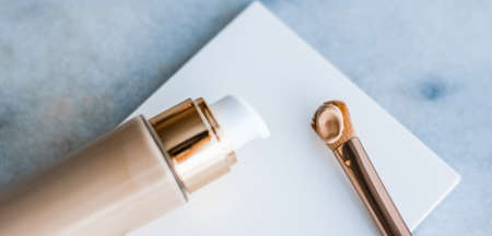 Cosmetic branding, glamour and skincare concept - Makeup foundation bottle and contouring brush on marble, make-up concealer bb cream as cosmetics product for luxury beauty brand holiday designの写真素材