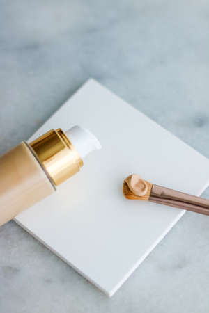 Cosmetic branding, glamour and skincare concept - Makeup foundation bottle and contouring brush on marble, make-up concealer bb cream as cosmetics product for luxury beauty brand holiday designの写真素材