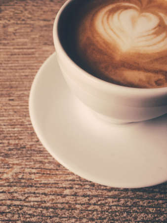 Morning drink, breakfast and rustic style concept - Cup of hot cappuccino in a cafeteria, coffee on a wooden table in cafeの写真素材