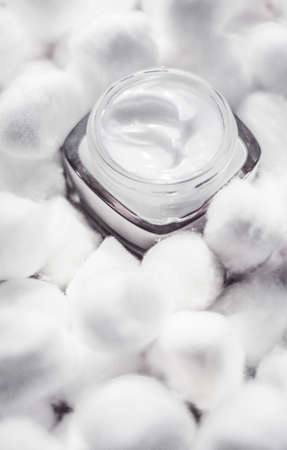 Cosmetic branding, moisturizing emulsion and facial care concept - Luxury face cream for sensitive skin and white cotton balls on background, spa cosmetics and natural skincare beauty brand productの写真素材