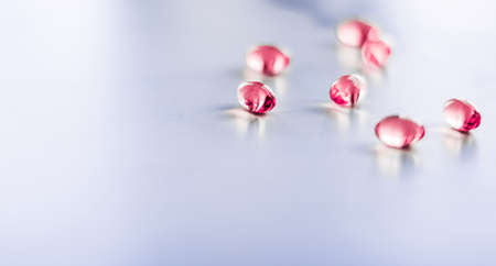 Pharmaceutical, branding and science concept - Red pills for healthy diet nutrition, supplements pill and probiotics capsules, healthcare and medicine as pharmacy and scientific research backgroundの写真素材