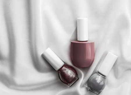 Cosmetic branding, salon and glamour concept - Nail polish bottles on silk background, french manicure products and nailpolish make-up cosmetics for luxury beauty brand and holiday flatlay art designの写真素材