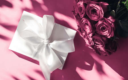Happy holidays, luxe shopping and love gifts concept - Luxury holiday silk gift box and bouquet of roses on pink background, romantic surprise and flowers as birthday or Valentines Day presentの写真素材