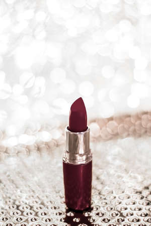 Cosmetic branding, sale and glamour concept - Chocolate lipstick on silver Christmas, New Years and Valentines Day holiday glitter background, make-up and cosmetics product for luxury beauty brandの写真素材