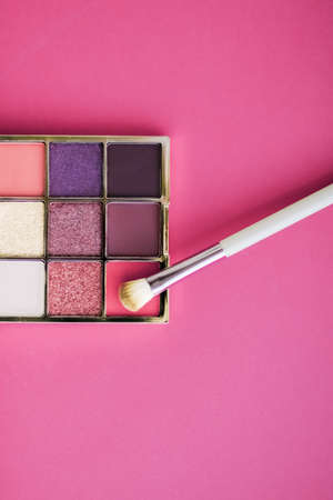 Cosmetic branding, mua and girly concept - Eyeshadow palette and make-up brush on rose background, eye shadows cosmetics product for luxury beauty brand promotion and holiday fashion blog designの写真素材
