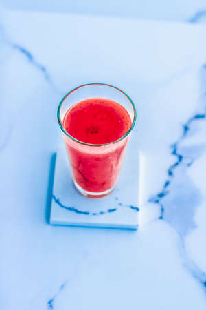 Branding, fasting and cleanse concept - Berry fruit juice in glass, vegan smoothie with chia for...