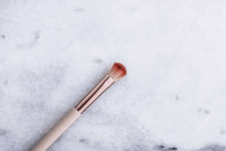 Cosmetic branding, blog and girly concept - Make-up brush for foundation base face contouring on marble background, mua cosmetics as glamour makeup artist product for luxury beauty brand art designの写真素材