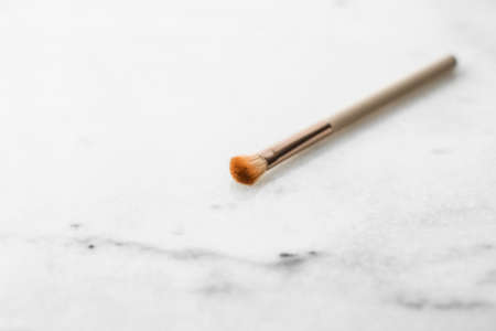 Cosmetic branding, blog and girly concept - Make-up brush for foundation base face contouring on marble background, mua cosmetics as glamour makeup artist product for luxury beauty brand art designの写真素材