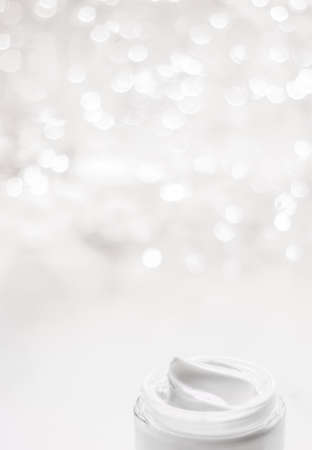 Cosmetic branding, gift and spa concept - Facial cream moisturizer jar on holiday glitter background, moisturizing skin care as lifting emulsion, anti-age cosmetics for luxury beauty skincare brandの写真素材