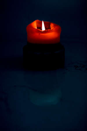 Happy holidays, greeting card backdrop and winter season concept - Red holiday candle on dark background, luxury branding design and decoration for Christmas, New Years Eve and Valentines Dayの写真素材