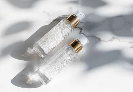 Cosmetic branding, packaging and make-up concept - Skin care serum and gel bottle, moisturizing lotion and lifting cream emulsion on marble, anti-age cosmetics for luxury beauty skincare brand designの写真素材