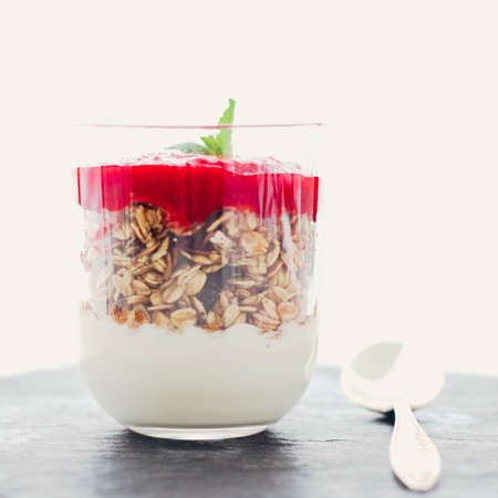 Sweet food, diet nutrition and organic dairy concept - Homemade granola parfait with strawberry jam and mint, yogurt and muesli for healthy breakfast in the morningの写真素材