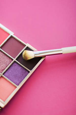 Cosmetic branding, mua and girly concept - Eyeshadow palette and make-up brush on rose background, eye shadows cosmetics product for luxury beauty brand promotion and holiday fashion blog designの写真素材