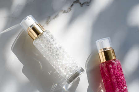 Cosmetic branding, packaging and make-up concept - Skin care serum and gel bottle, moisturizing lotion and lifting cream emulsion on marble, anti-age cosmetics for luxury beauty skincare brand designの写真素材