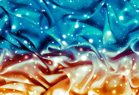 Winter fashion, shiny fabric and glamour style concept - Magic holiday blue and gold soft silk flatlay background texture with glowing snow, luxury beauty abstract backdropの写真素材