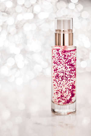Cosmetic branding, blank label and glamour present concept - Holiday make-up base gel, serum emulsion, lotion bottle and silver glitter, luxury skin and body care cosmetics for beauty brand adsの写真素材