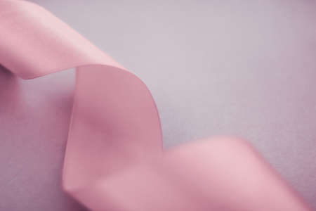 Branding, holidays and luxe brands concept - Abstract silk ribbon on blush pink background,...