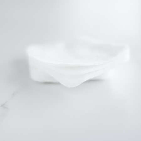 Cosmetology, cleanliness and branding concept - Organic cotton pads on marble background, cosmetics and make-up remover, hygiene and skincare beauty brand product for healthcare and medical designの写真素材