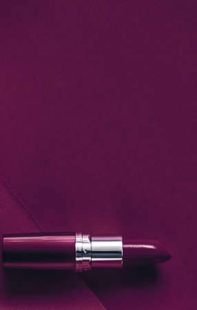Cosmetic branding, glamour lip gloss and shopping sale concept - Luxury lipstick and silk ribbon on plum holiday background, make-up and cosmetics flatlay for beauty brand product designの写真素材