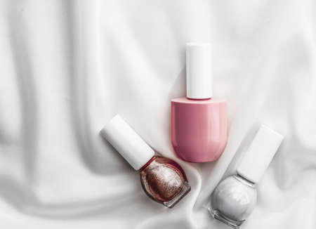 Cosmetic branding, salon and glamour concept - Nail polish bottles on silk background, french manicure products and nailpolish make-up cosmetics for luxury beauty brand and holiday flatlay art designの写真素材