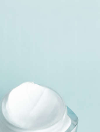 Cosmetic branding, toiletries and spf concept - Face cream moisturizer jar on mint background,...