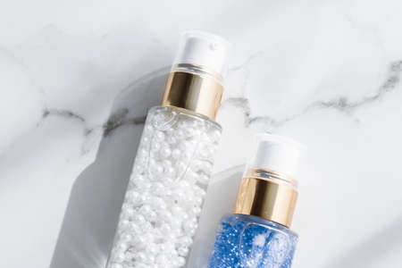 Cosmetic branding, packaging and make-up concept - Skin care serum and gel bottle, moisturizing lotion and lifting cream emulsion on marble, anti-age cosmetics for luxury beauty skincare brand designの写真素材
