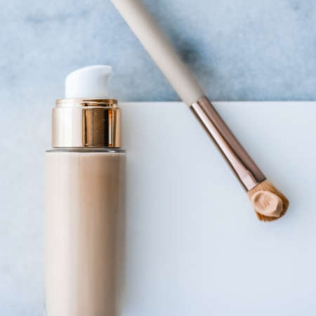 Cosmetic branding, glamour and skincare concept - Makeup foundation bottle and contouring brush on marble, make-up concealer bb cream as cosmetics product for luxury beauty brand holiday designの写真素材
